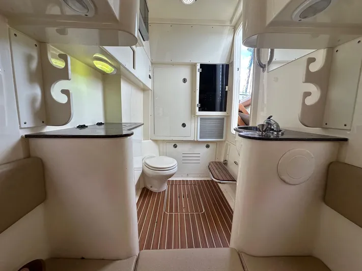  Yacht Photos Pics Interior of 2015 Scout 350 LXF boat featuring a compact bathroom with toilet and sink.