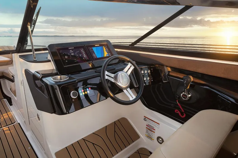  Yacht Photos Pics Manufacturer Provided Image: 2025 Sea Ray SLX 260 boat interior with modern dashboard and steering wheel at sunset.