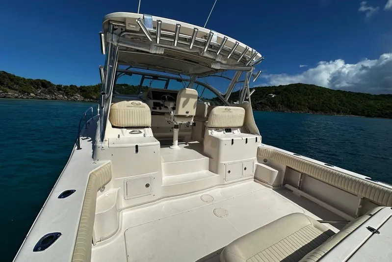  Yacht Photos Pics 2006 Grady-White Express 360 boat on clear blue water, sunny day, lush green island backdrop.