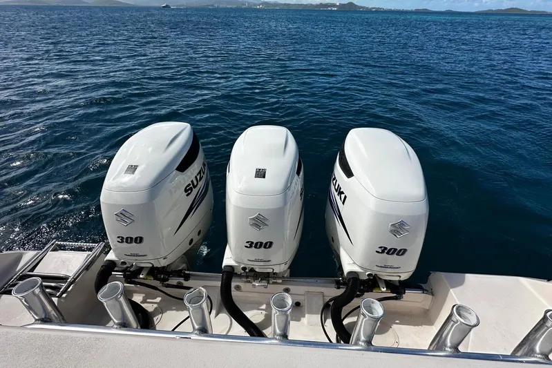  Yacht Photos Pics Triple Suzuki 300 outboard engines on a 2006 Grady-White Express 360 boat, ocean backdrop.