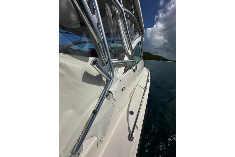  Yacht Photos Pics 2006 Grady-White Express 360 boat on water, side view with railing and canopy.
