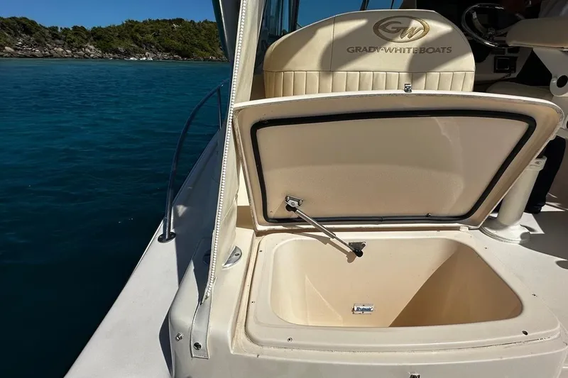  Yacht Photos Pics 2006 Grady-White Express 360 boat with open storage compartment, near scenic shoreline.
