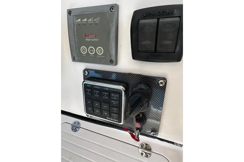  Yacht Photos Pics Control panel of a 2006 Grady-White Express 360 boat with Suzuki controls.