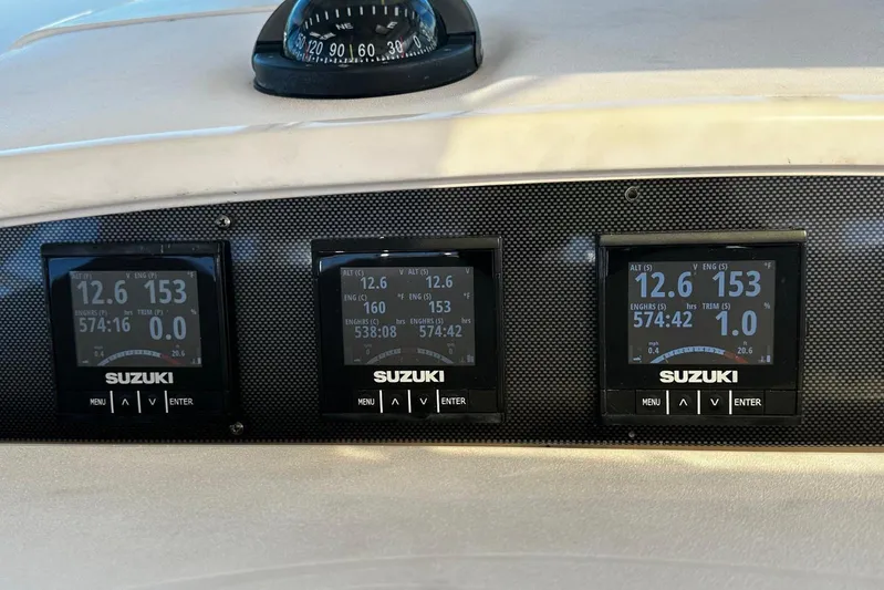 Yacht Photos Pics 2006 Grady-White Express 360 dashboard with Suzuki engine displays and compass.