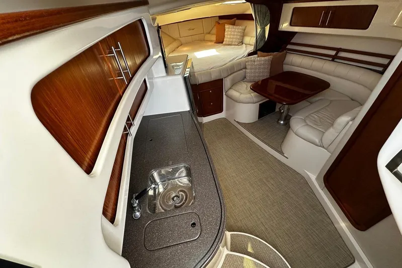  Yacht Photos Pics Luxurious interior of 2006 Grady-White Express 360 boat with kitchenette and seating area.