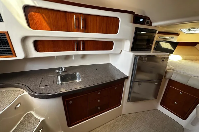  Yacht Photos Pics 2006 Grady-White Express 360 interior with kitchenette, sink, and storage cabinets.