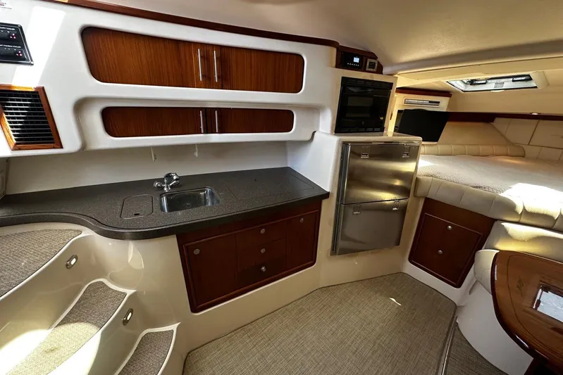  Yacht Photos Pics 2006 Grady-White Express 360 cabin interior with kitchenette, sink, and seating area.
