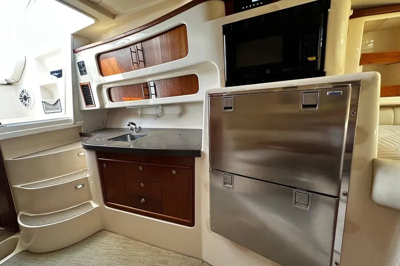  Yacht Photos Pics 2006 Grady-White Express 360 interior with kitchenette, stainless appliances, and wooden cabinetry.