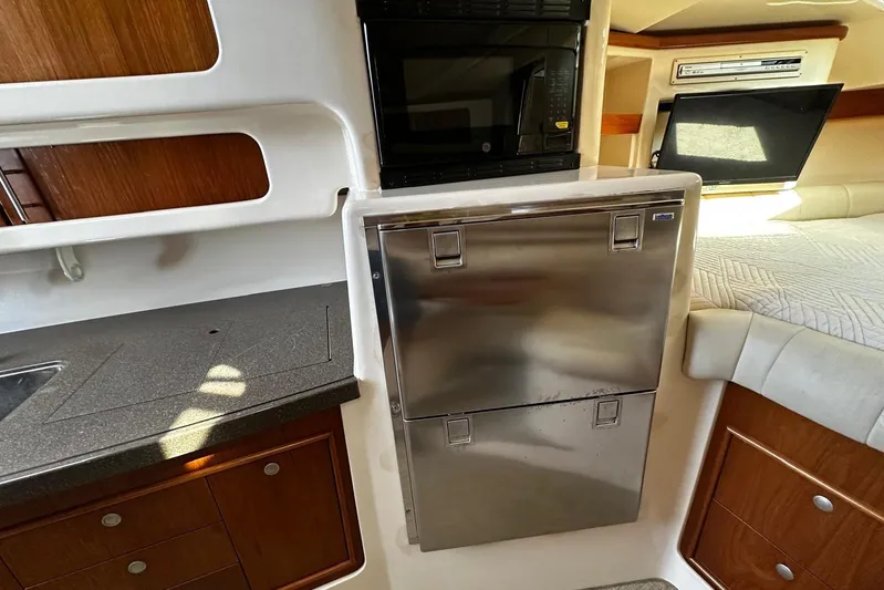  Yacht Photos Pics 2006 Grady-White Express 360 interior with kitchenette, stainless steel fridge, and microwave.