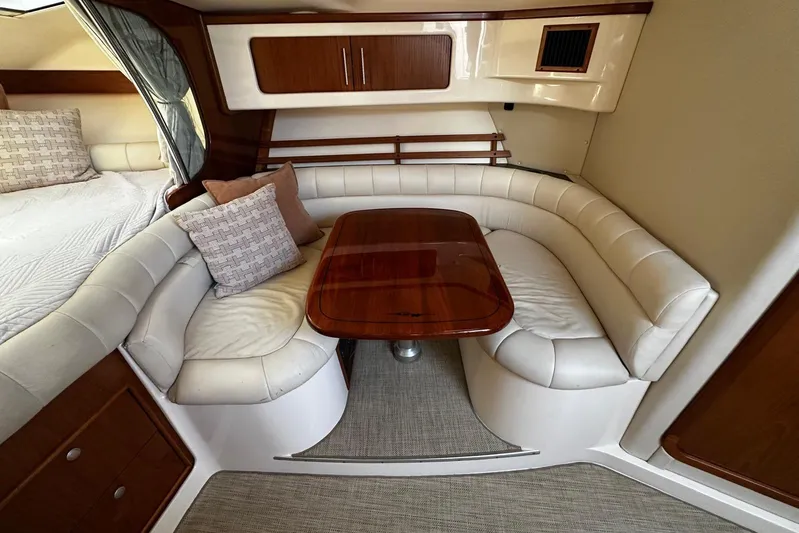  Yacht Photos Pics 2006 Grady-White Express 360 interior with white leather seating and wooden table.