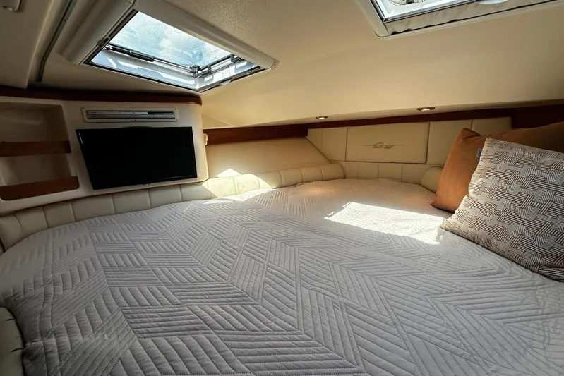 Yacht Photos Pics Luxurious cabin interior of 2006 Grady-White Express 360 with cozy bedding and natural light.