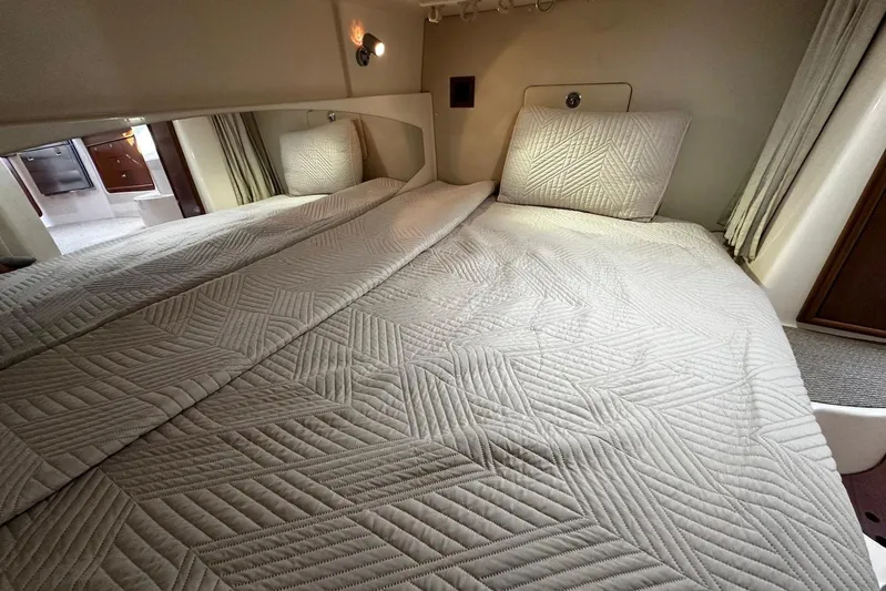  Yacht Photos Pics Interior cabin of 2006 Grady-White Express 360 with quilted bedding and modern design.