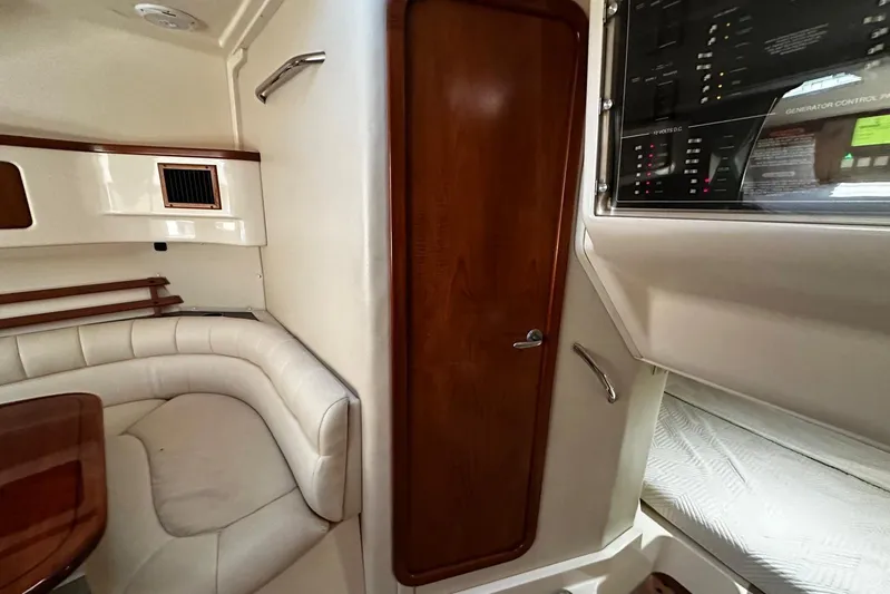  Yacht Photos Pics 2006 Grady-White Express 360 cabin interior with seating, control panel, and wooden door.