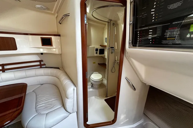  Yacht Photos Pics 2006 Grady-White Express 360 cabin interior with seating, bathroom, and control panel.
