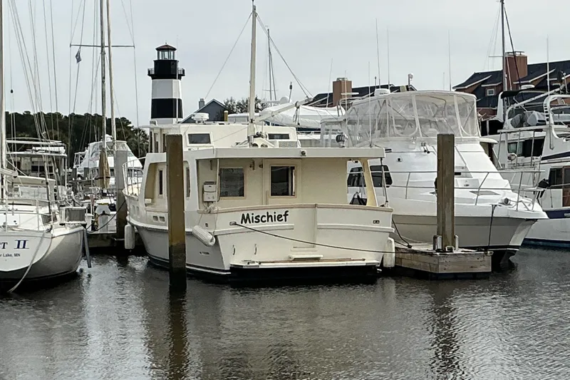  Yacht Photos Pics 2009 Hugh Huff Custom Pilothouse Trawler "Mischief" docked in a marina.