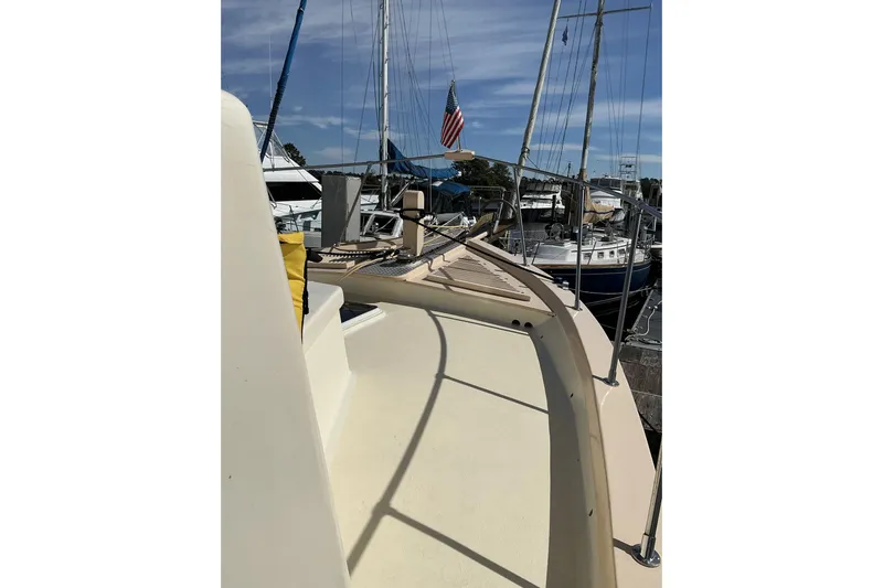  Yacht Photos Pics 2009 Hugh Huff Custom Pilothouse Trawler docked, showcasing deck and marina view.