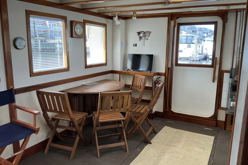  Yacht Photos Pics Interior of 2009 Hugh Huff Custom Pilothouse Trawler with wooden furniture and nautical decor.