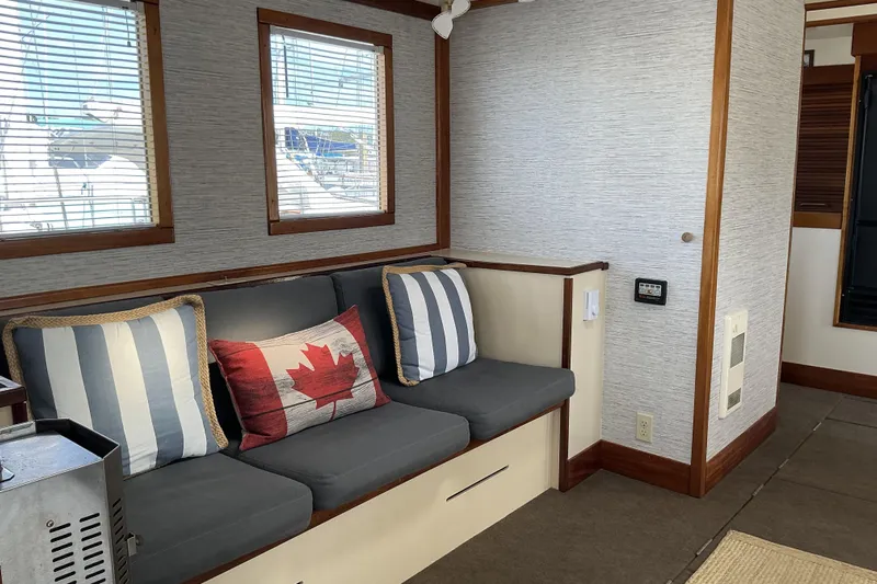  Yacht Photos Pics Interior of 2009 Hugh Huff Custom Pilothouse Trawler with cozy seating and nautical decor.