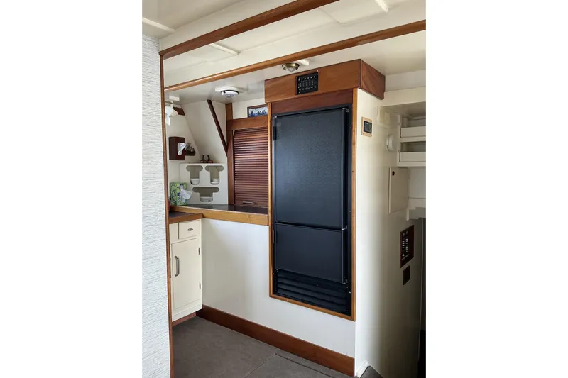  Yacht Photos Pics 2009 Hugh Huff Custom Pilothouse Trawler interior with wooden cabinetry and modern appliances.