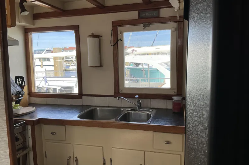  Yacht Photos Pics Interior of 2009 Hugh Huff Custom Pilothouse Trawler with kitchen sink and marina view.