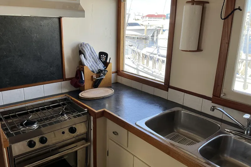  Yacht Photos Pics Pilothouse trawler kitchen with stove, sink, and utensils, 2009 Hugh Huff Custom model.