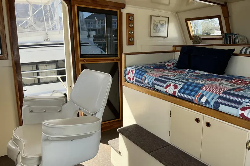  Yacht Photos Pics Interior of 2009 Hugh Huff Custom Pilothouse Trawler with seating and cozy bed area.
