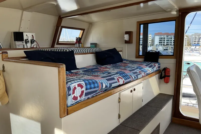  Yacht Photos Pics Interior of 2009 Hugh Huff Custom Pilothouse Trawler with nautical-themed seating and windows.
