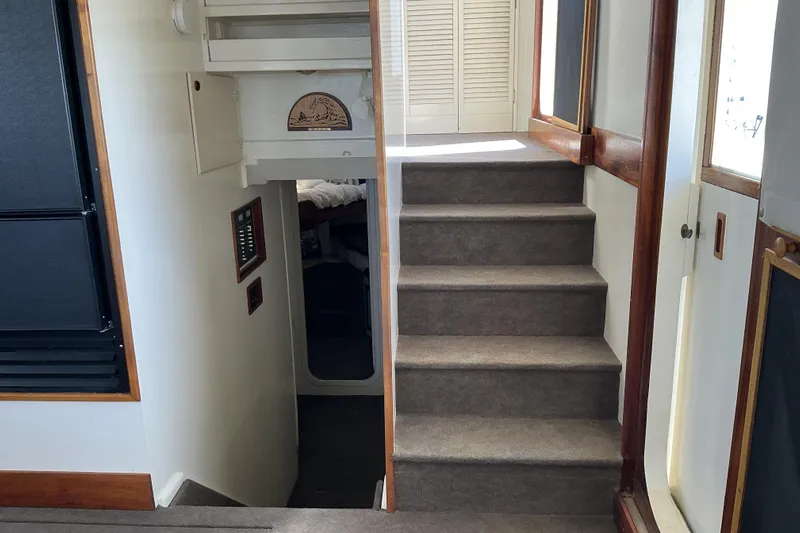  Yacht Photos Pics Interior stairs of 2009 Hugh Huff Custom Pilothouse Trawler, featuring carpet and wood accents.