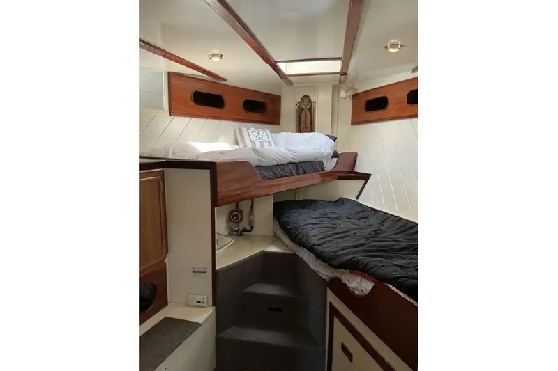  Yacht Photos Pics Interior of 2009 Hugh Huff Custom Pilothouse Trawler with cozy bunk beds and wooden accents.