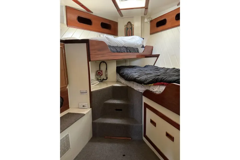  Yacht Photos Pics Interior of 2009 Hugh Huff Custom Pilothouse Trawler with bunk beds and wooden accents.