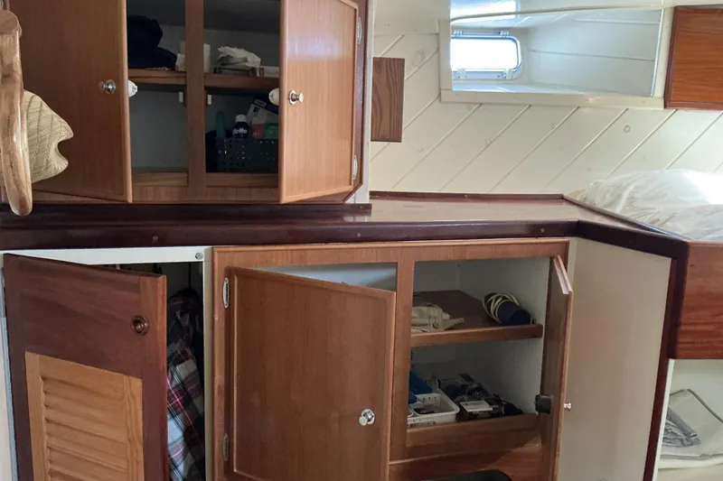  Yacht Photos Pics Interior of 2009 Hugh Huff Custom Pilothouse Trawler with open wooden cabinets and storage.