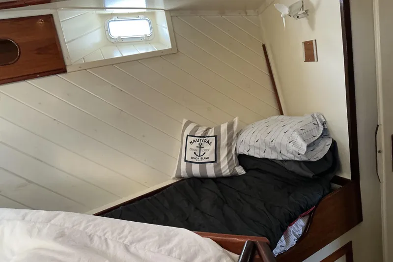  Yacht Photos Pics Cozy cabin bed in 2009 Hugh Huff Custom Pilothouse Trawler with nautical decor.