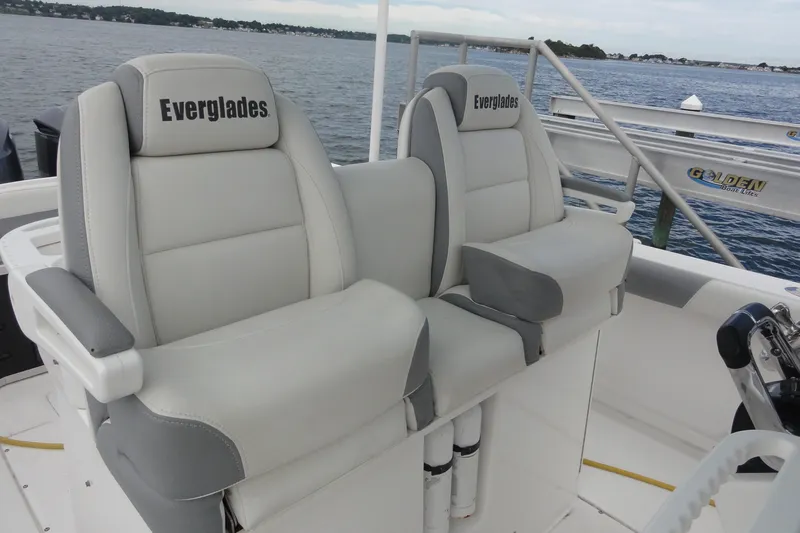  Yacht Photos Pics 2016 Everglades 295 Center Console boat seats with logo, docked by the water.
