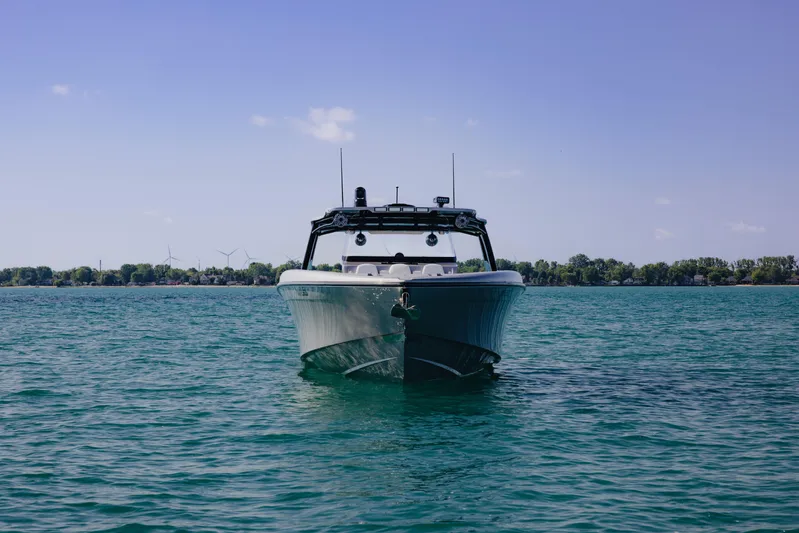 Yacht Photos Pics 2021 Midnight Express 43 Open boat on calm water under clear blue sky.