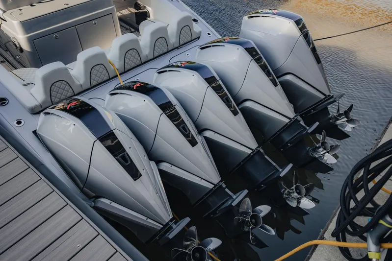  Yacht Photos Pics Five powerful outboard motors on a 2021 Midnight Express 43 Open boat docked by the water.