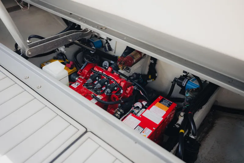  Yacht Photos Pics Engine compartment of a 2021 Midnight Express 43 Open boat, showcasing red machinery and components.