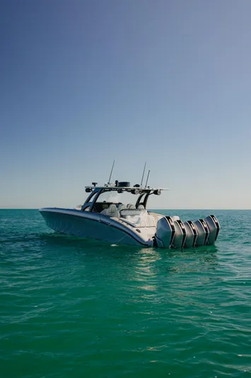  Yacht Photos Pics 2021 Midnight Express 43 Open boat on calm turquoise sea under clear sky.