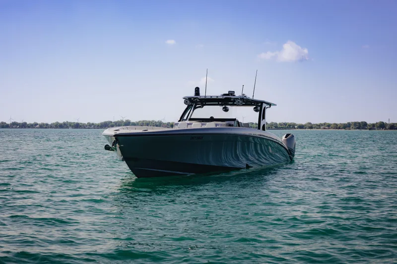  Yacht Photos Pics 2021 Midnight Express 43 Open boat on calm water under clear blue sky.