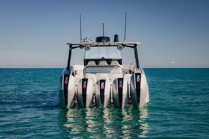  Yacht Photos Pics 2021 Midnight Express 43 Open boat with four powerful outboard engines on calm sea.
