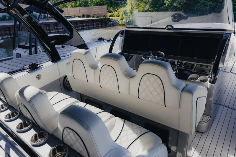  Yacht Photos Pics 2021 Midnight Express 43 Open boat interior with luxurious white seating and modern dashboard.