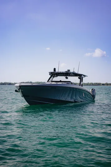  Yacht Photos Pics 2021 Midnight Express 43 Open boat on calm water under clear blue sky.