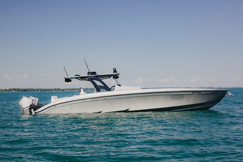  Yacht Photos Pics 2021 Midnight Express 43 Open boat on calm blue water under clear sky.