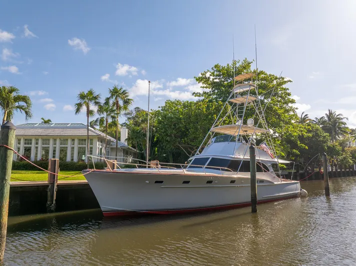Ta-boo Yacht Photos Pics 1970 Rybovich 54 yacht docked by a tropical waterfront home.