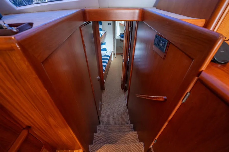 Ta-boo Yacht Photos Pics Interior view of a 1970 Rybovich 54 yacht, featuring wooden stairs and cabin access.