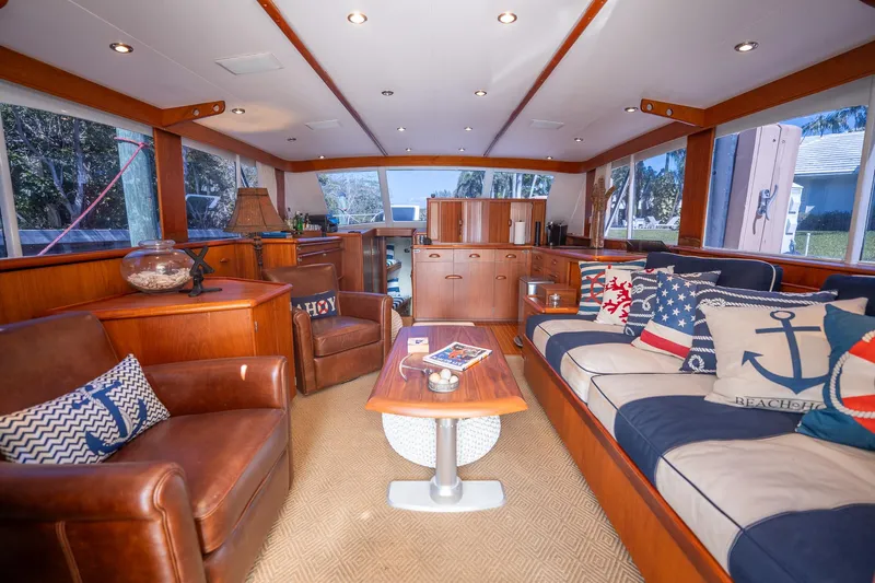 Ta-boo Yacht Photos Pics Luxurious 1970 Rybovich 54 yacht interior with leather seating and nautical-themed decor.