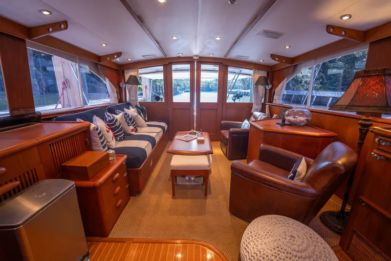 Ta-boo Yacht Photos Pics Luxurious interior of a 1970 Rybovich 54 yacht with elegant wood finishes and plush seating.