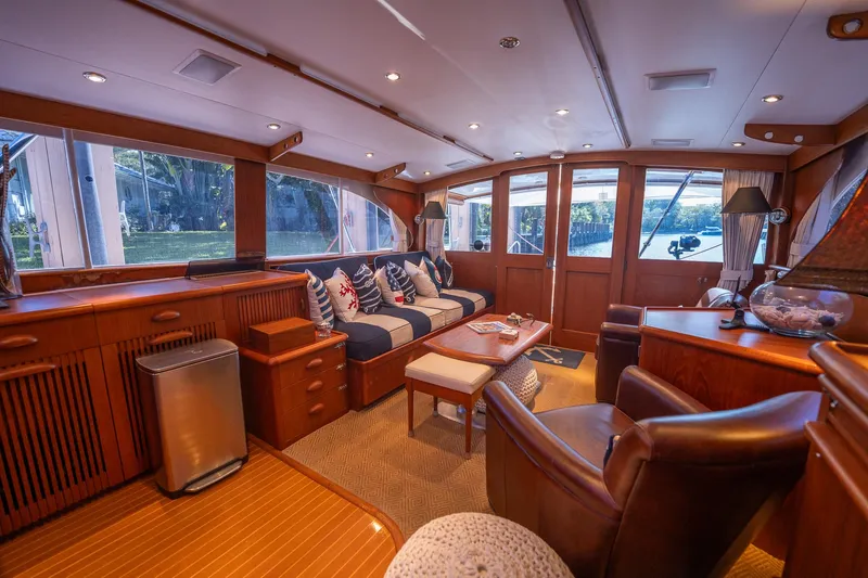 Ta-boo Yacht Photos Pics Luxurious interior of a 1970 Rybovich 54 yacht with elegant wood finishes and plush seating.