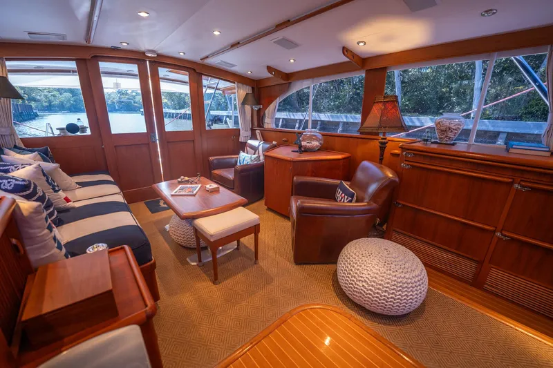 Ta-boo Yacht Photos Pics Luxurious interior of a 1970 Rybovich 54 yacht with elegant wood finishes and comfortable seating.