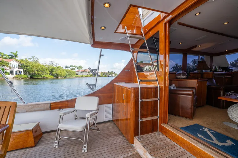 Ta-boo Yacht Photos Pics Luxurious 1970 Rybovich 54 yacht interior with wooden finishes and scenic water view.
