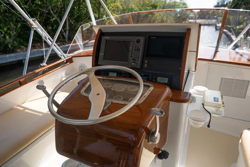 Ta-boo Yacht Photos Pics Helm of 1970 Rybovich 54 yacht with wooden steering wheel and navigation equipment.